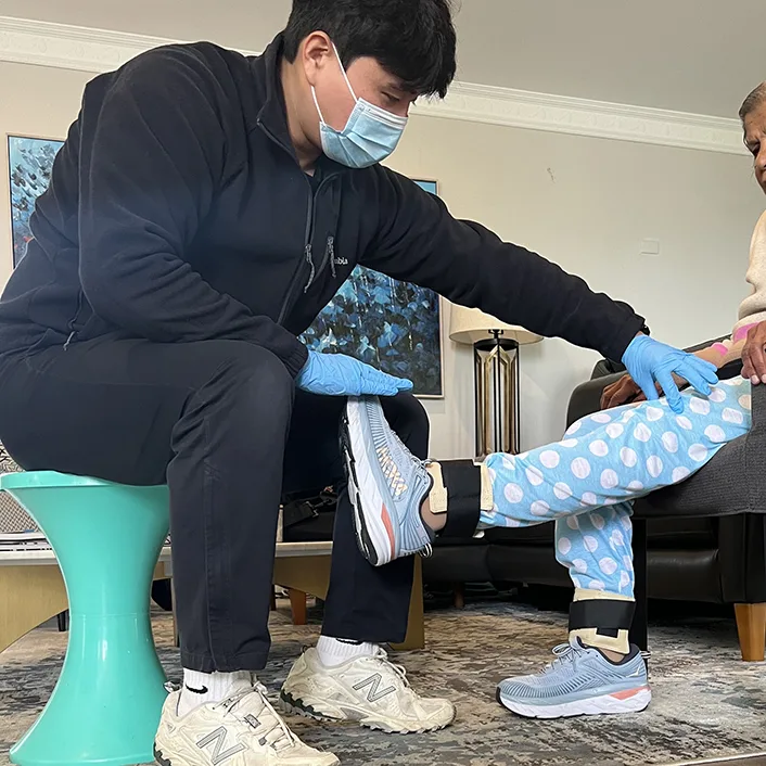 Physiotherapist performing leg stretch on patient during physical therapy session